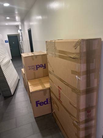 Stacked boxes ready for loading in building hallway